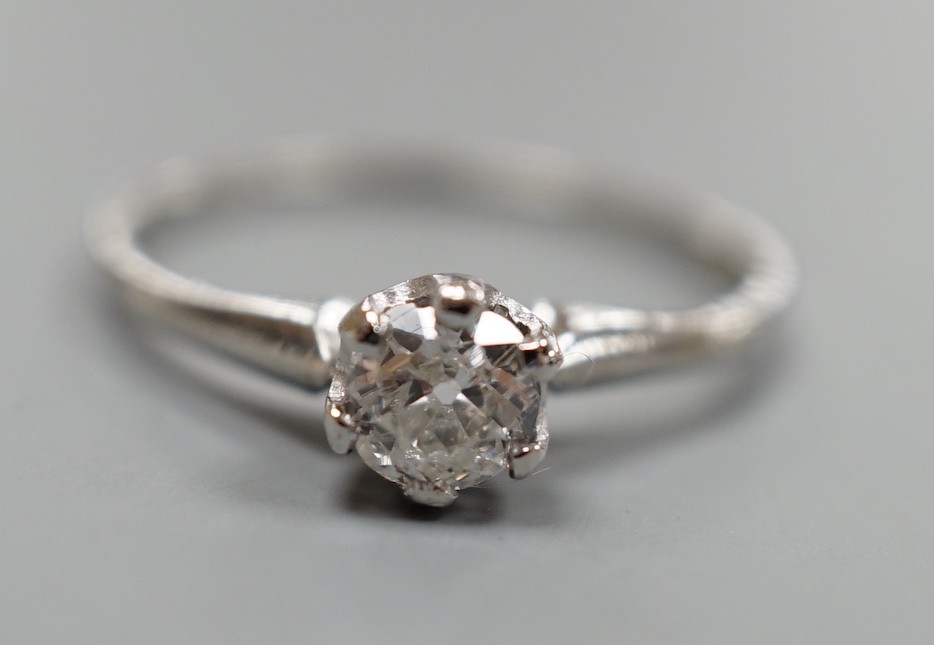 A white metal (stamped plat) and solitaire diamond ring, size O, gross weight 2.3 grams.